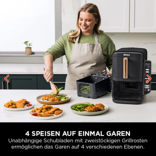 Frau serviert Gericht direkt aus dem Airfryer auf der Küchenplatte
